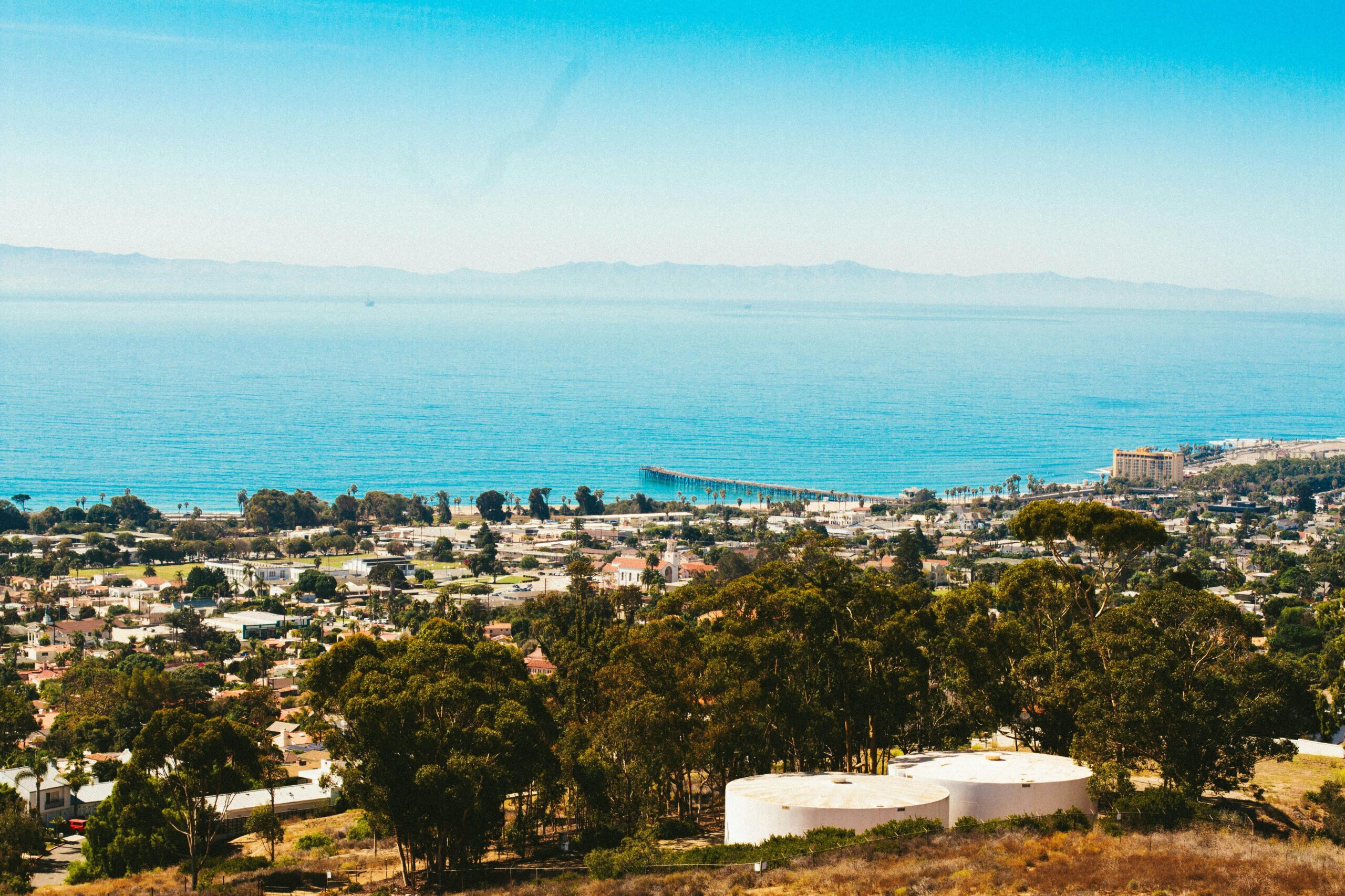 A stunning aerial view of Ventura, California capturing the coastal town and ocean on a sunny day.