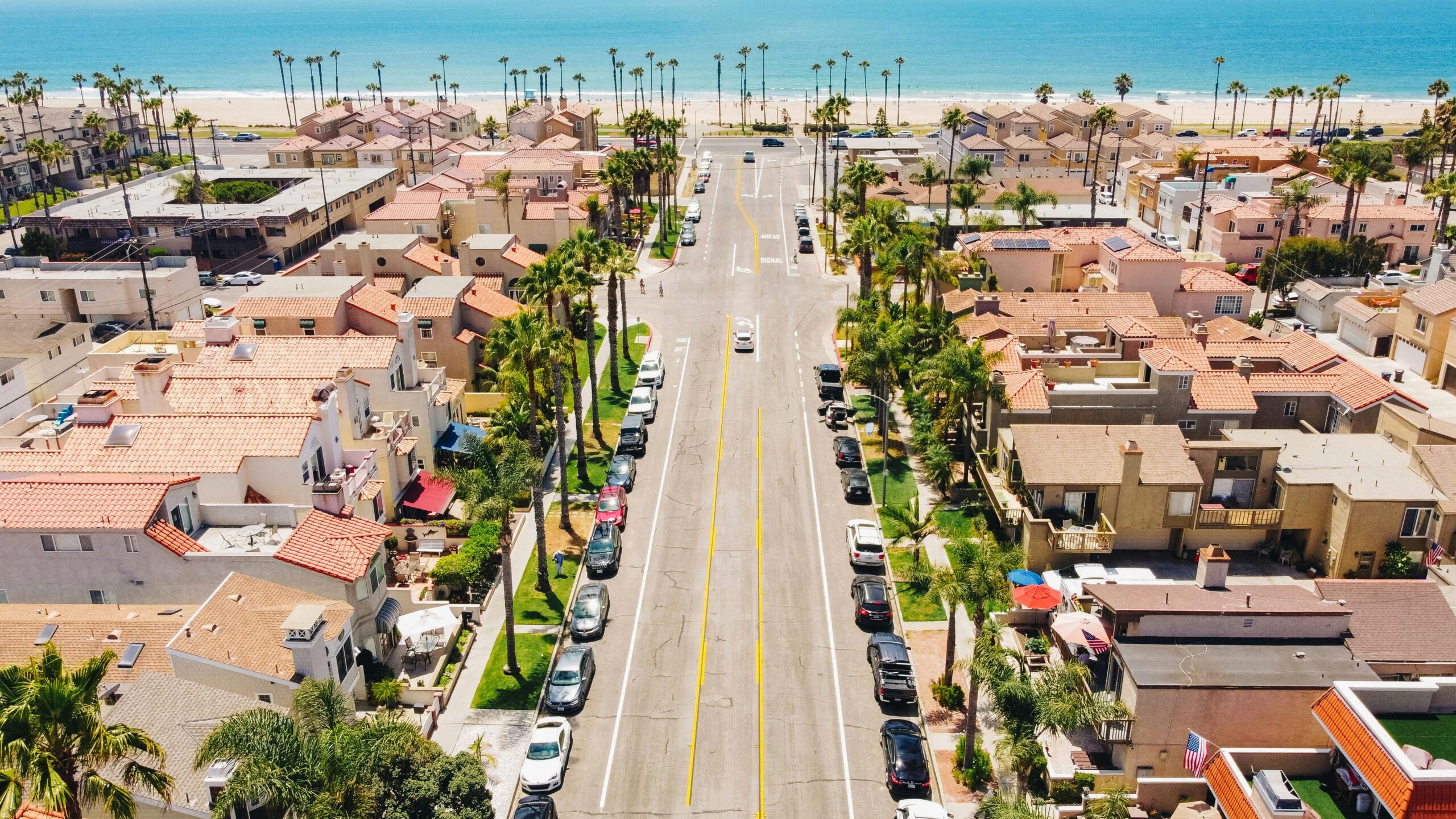 Explore Huntington Beach's beautiful neighborhood and coastline in this vibrant aerial shot.