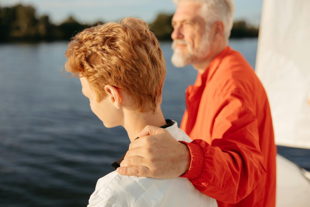 A heartwarming moment between grandfather and grandson enjoying a summer boat ride.