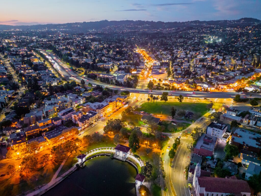Aerial view of a bustling city with illuminated highways and buildings at night.
