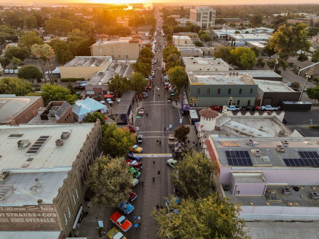 Aerial view capturing the vibrant city streets of Woodland, CA at sunset.